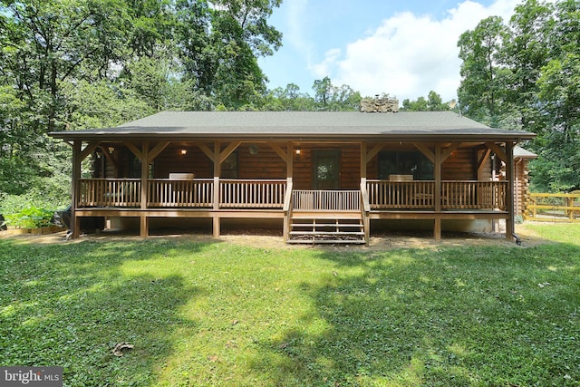 cabin featuring a front lawn