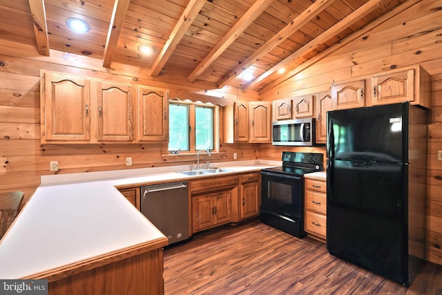 kitchen with black appliances, wood walls, sink, and dark wood-type flooring