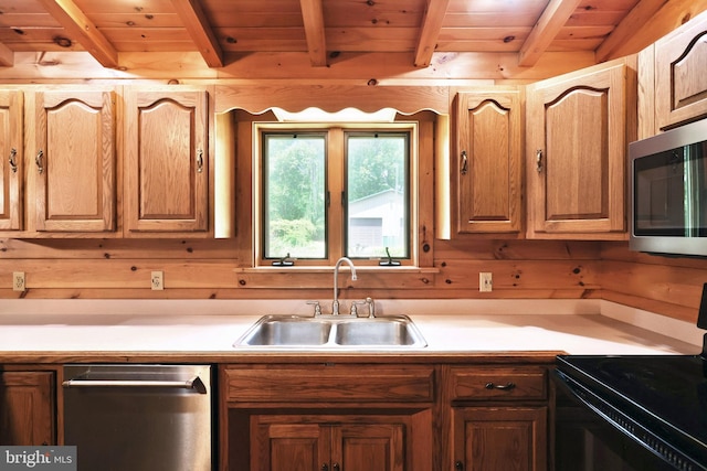 kitchen with beam ceiling, stainless steel appliances, wooden ceiling, and sink