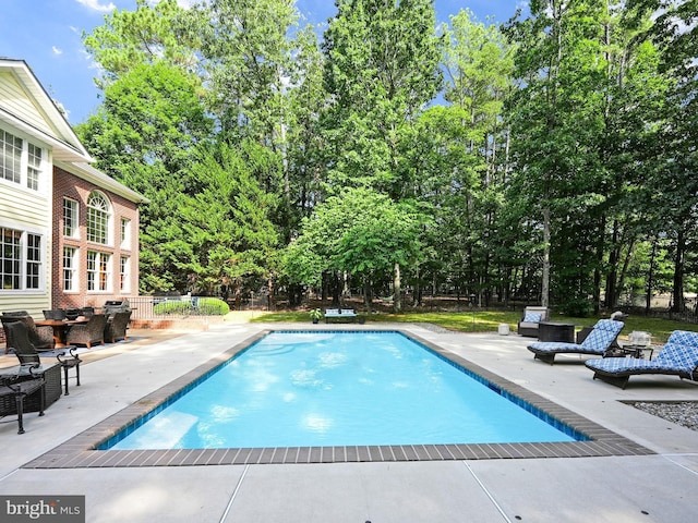 view of swimming pool featuring a patio area