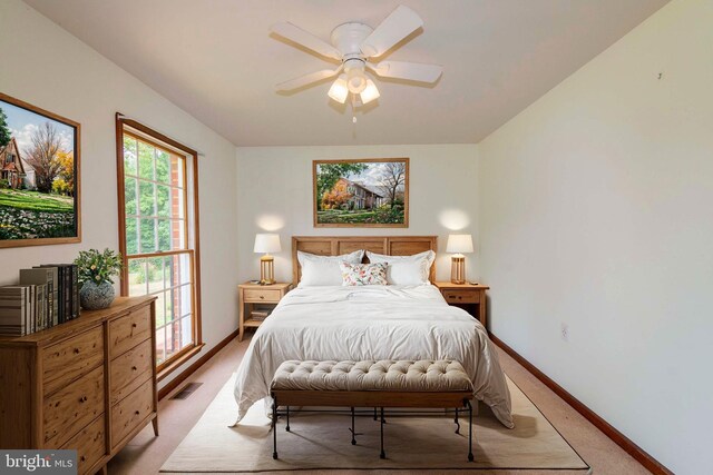 bedroom featuring ceiling fan and light carpet