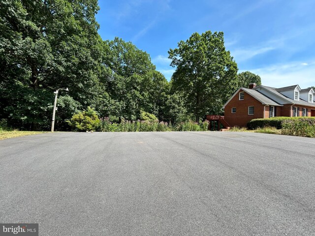 back of property with a wooden deck, a lawn, and central air condition unit