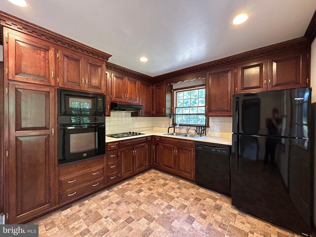 kitchen featuring sink, black appliances, and decorative backsplash