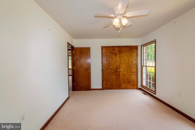 unfurnished bedroom with ceiling fan and carpet floors