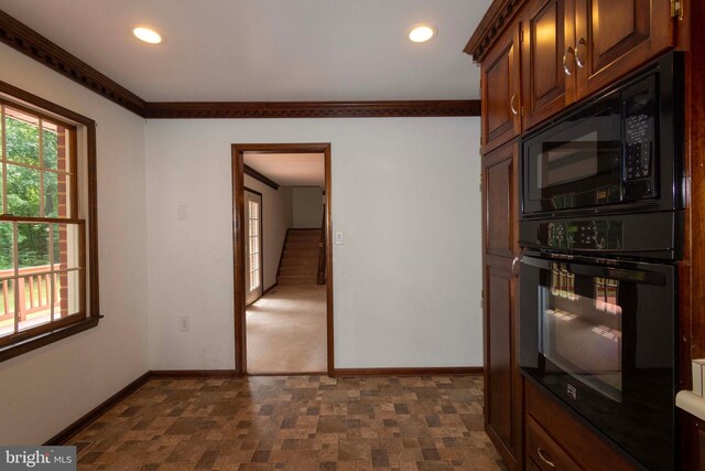 kitchen with black appliances and crown molding