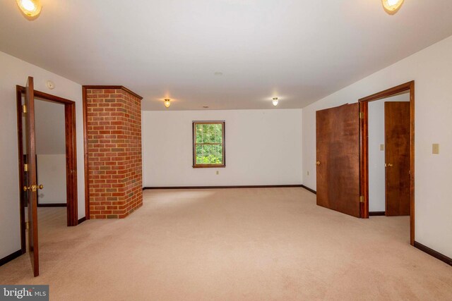 spare room featuring light colored carpet