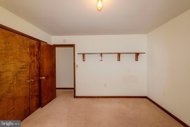 unfurnished room with light colored carpet