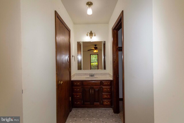 hallway featuring sink and light tile patterned floors