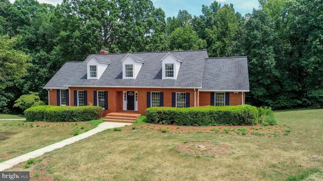 new england style home with a front yard