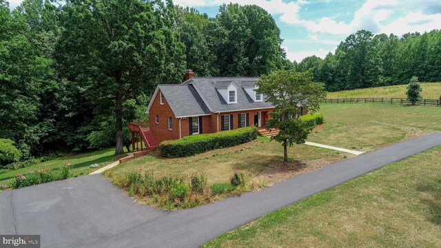 new england style home with a front yard