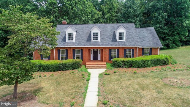 cape cod-style house with a front lawn