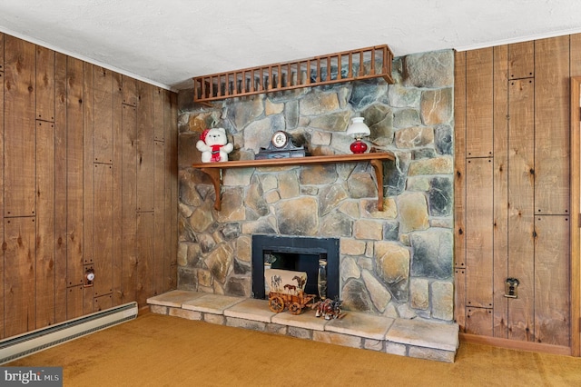 details with a baseboard heating unit, wooden walls, carpet floors, a fireplace, and ornamental molding