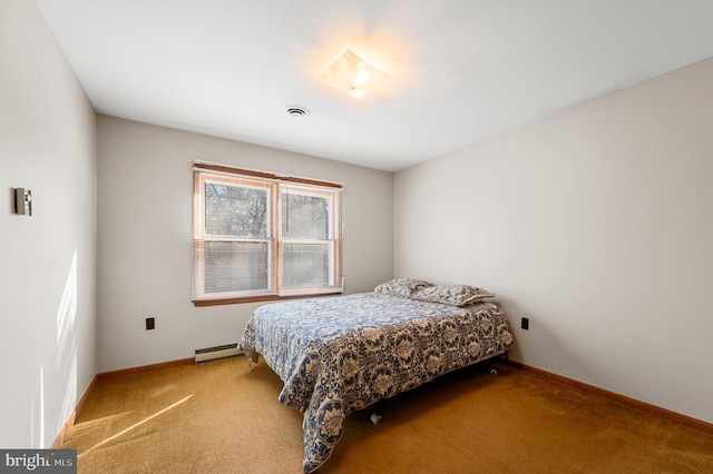 carpeted bedroom featuring a baseboard heating unit