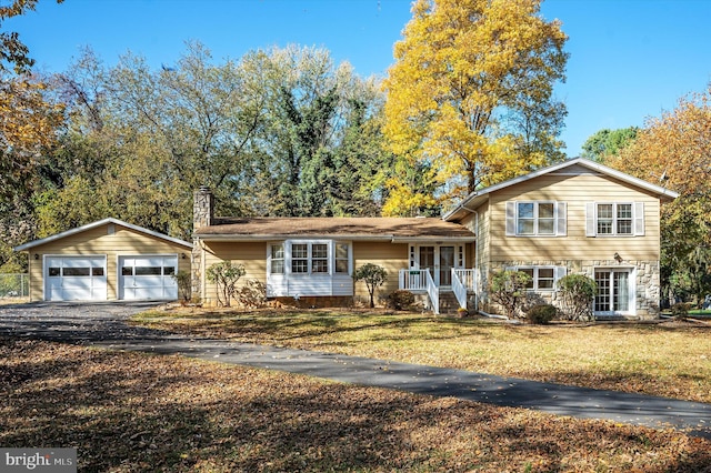 split level home featuring an outbuilding, a garage, and a front yard