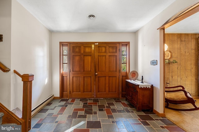 entrance foyer with wooden walls and baseboard heating