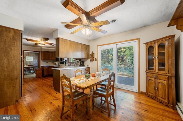 dining space with hardwood / wood-style flooring, a textured ceiling, and ceiling fan