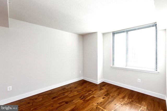 unfurnished room featuring dark hardwood / wood-style floors