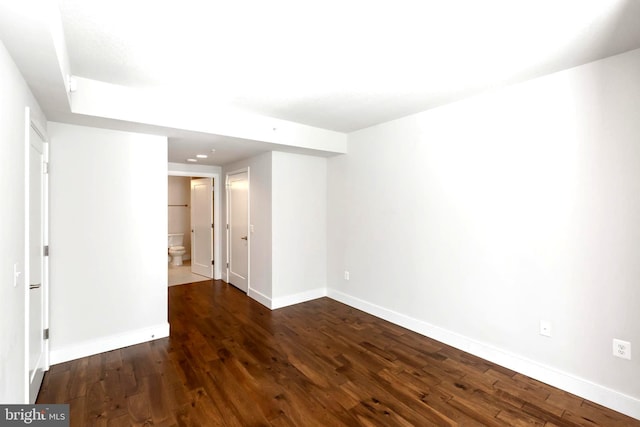 spare room with dark hardwood / wood-style flooring