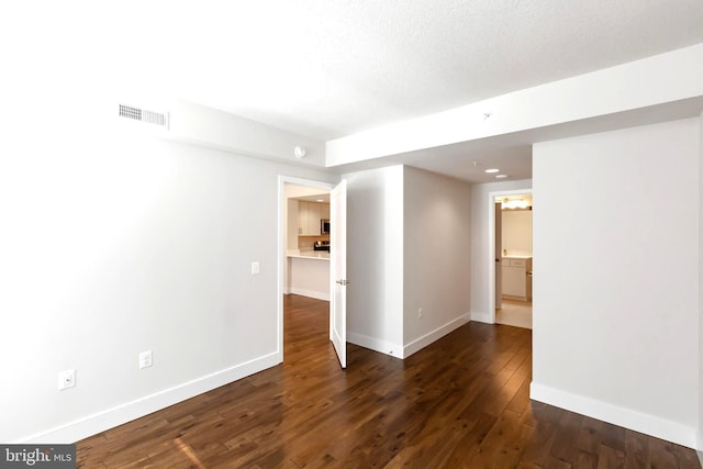 unfurnished room featuring dark hardwood / wood-style flooring