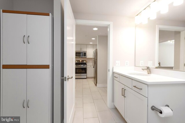 bathroom with tile patterned floors and vanity