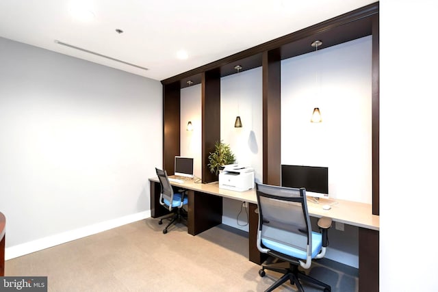 carpeted office with built in desk