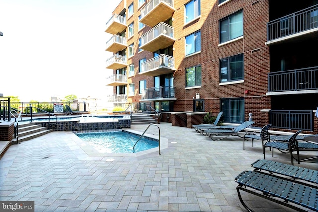 view of pool with pool water feature