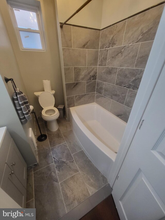 full bathroom featuring shower / washtub combination, tile patterned floors, toilet, and vanity