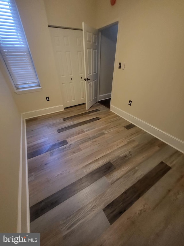 unfurnished bedroom with dark wood-type flooring