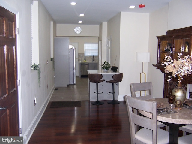 dining room with sink and dark hardwood / wood-style floors