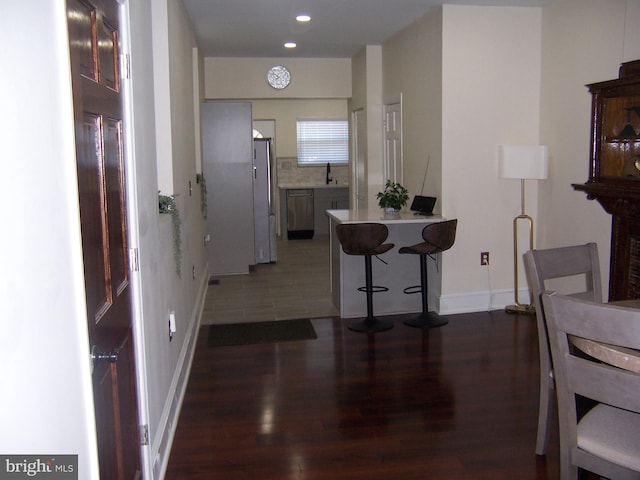 interior space with dark tile patterned floors and sink