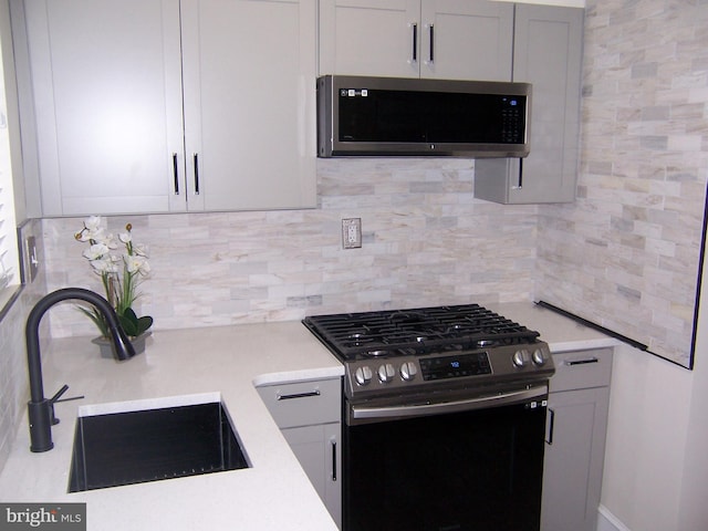 kitchen with sink, backsplash, and stainless steel appliances