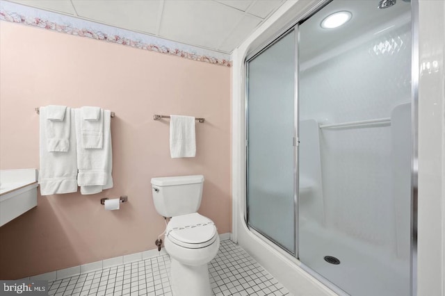 bathroom featuring tile patterned flooring, toilet, and an enclosed shower