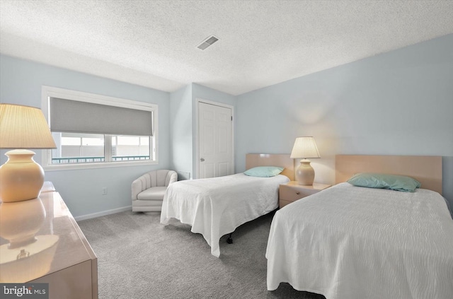 bedroom with carpet and a textured ceiling