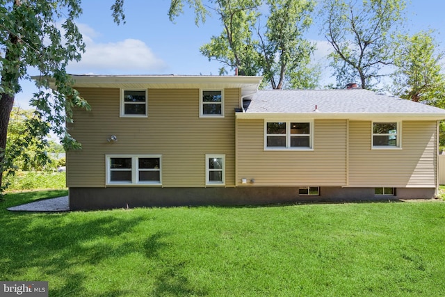 rear view of property featuring a yard