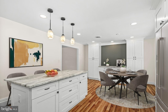 kitchen featuring white cabinetry, a breakfast bar, and a kitchen island