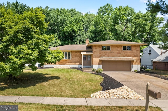 view of front of house with a garage and a front lawn