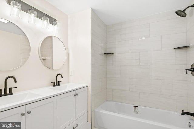 bathroom with vanity and tiled shower / bath