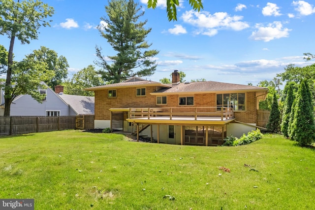 back of property with a deck and a lawn