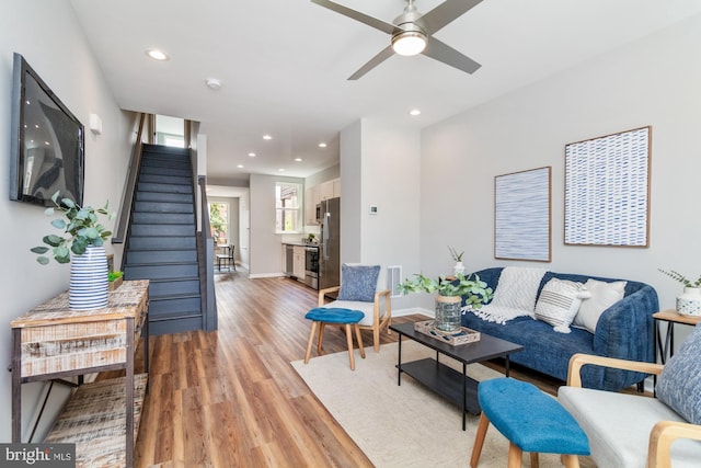 living room featuring ceiling fan and hardwood / wood-style floors