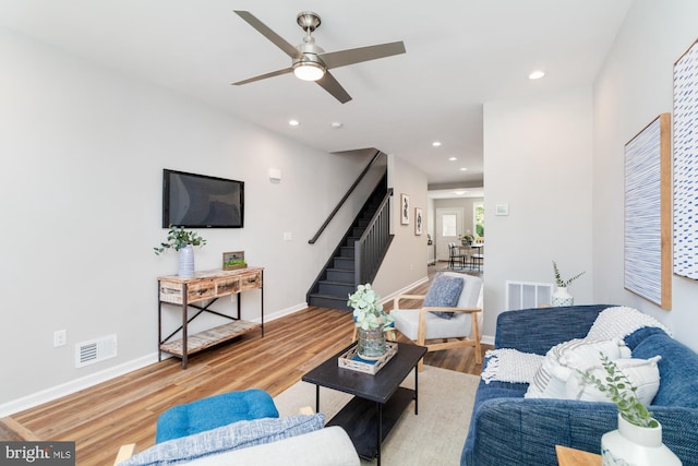 living room featuring light wood-type flooring and ceiling fan