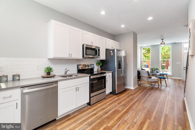 kitchen featuring white cabinetry, sink, ceiling fan, and stainless steel appliances