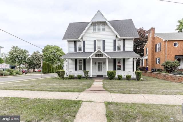 view of front of home with a porch and a front yard