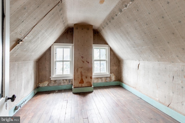 additional living space featuring hardwood / wood-style flooring and lofted ceiling