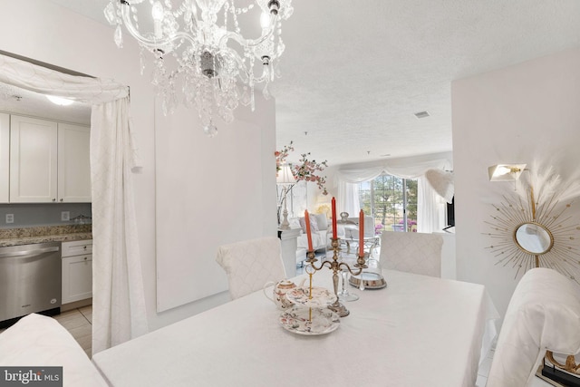 dining area with a textured ceiling and a chandelier