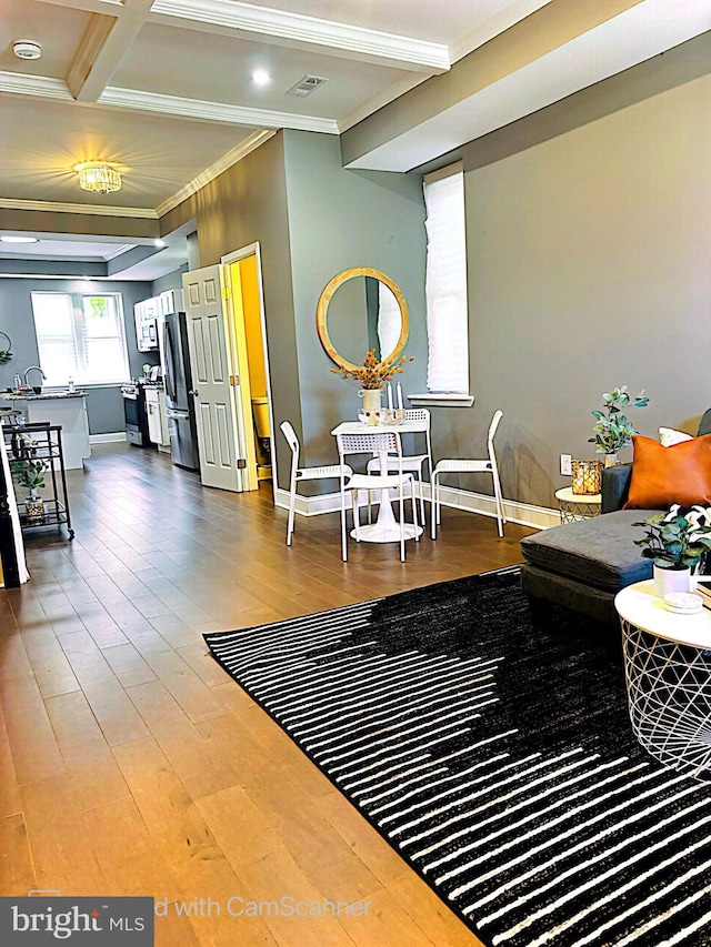 living room with ornamental molding, hardwood / wood-style flooring, beamed ceiling, and coffered ceiling