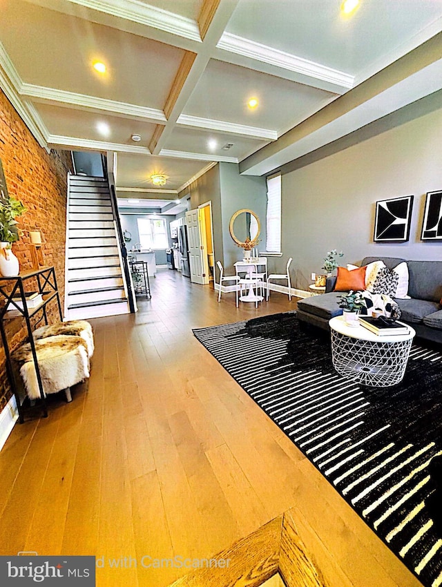 living room featuring crown molding, coffered ceiling, hardwood / wood-style flooring, and beamed ceiling