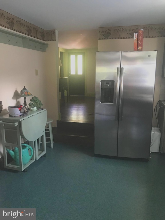 kitchen featuring carpet flooring and stainless steel refrigerator with ice dispenser