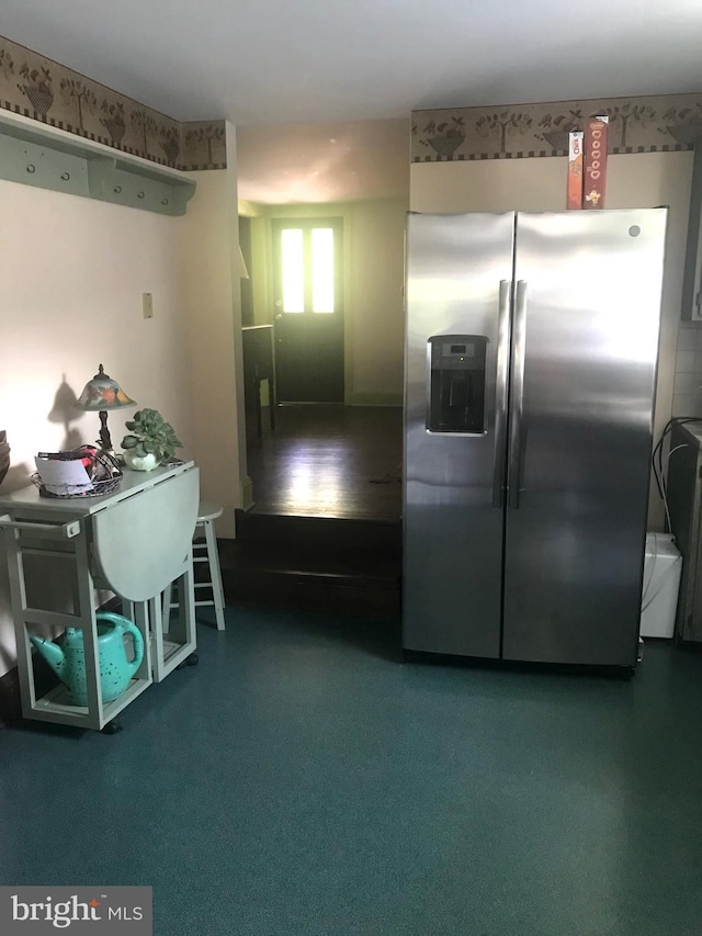 kitchen with stainless steel fridge and carpet