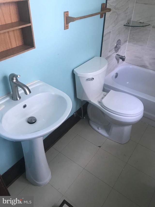 bathroom featuring tile patterned flooring, shower / washtub combination, and toilet