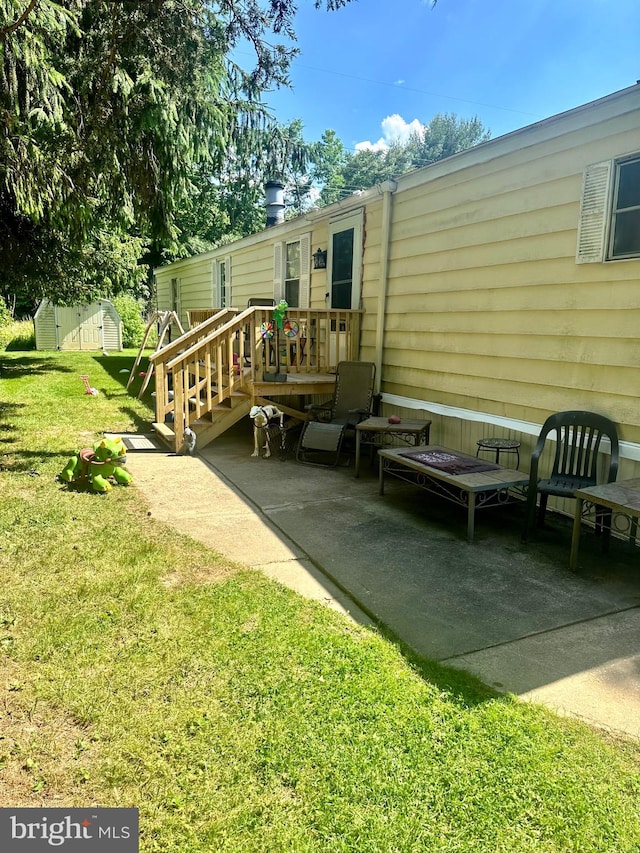 back of house featuring a patio area, an outdoor living space, and a yard